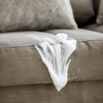 Mom applies shaving cream over stained couch. Here’s why